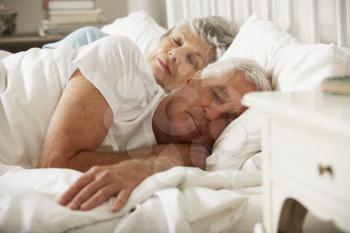 Senior Couple Asleep In Bed Together