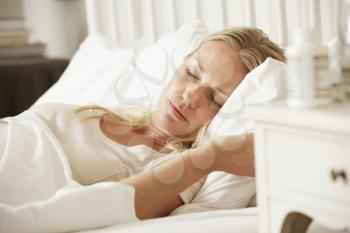 Medication On Bedside Table Of Sleeping Woman