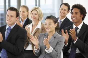 Group Of Business People Applauding Speaker At The End Of A Presentation