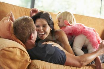 Family Lying On Sofa At Home