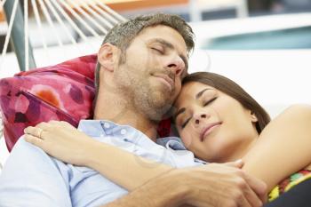 Romantic Couple Asleep In Garden Hammock Together