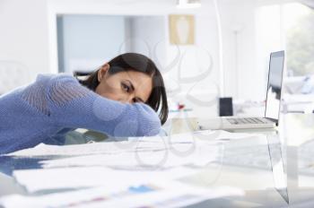Stressed Woman Working At Laptop In Home Office
