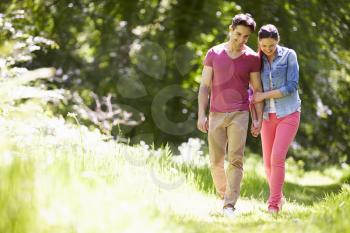 Young Couple Walking In Summer Countryside