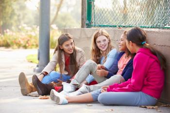 Four Young Girls Hanging Out Together In Park