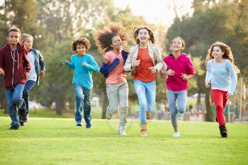 Group Of Young Children Running Towards Camera In Park