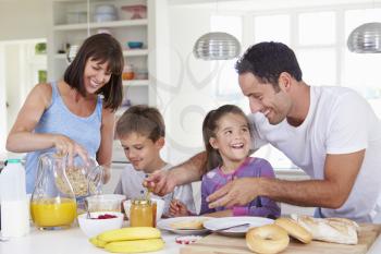 Family Making Breakfast In Kitchen Together