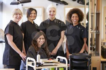 Teacher Helping Mature Students In Hairdressing
