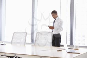 Businessman On Mobile Phone In Boardroom