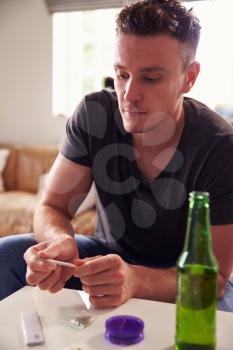 Young Man Smoking Marijuana At Home
