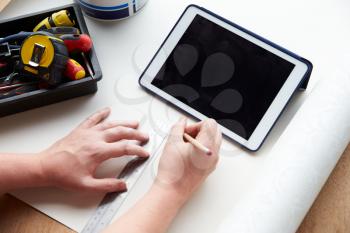 Man Plans Design Project Using Application On Digital Tablet