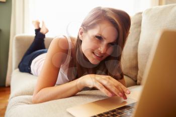 Unhappy Woman Using Laptop And Looking Concerned