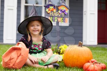 Portrait Of Girl Dressed In Trick Or Treating Witch Costume