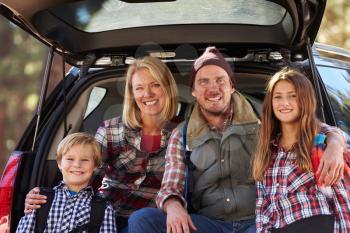 Portrait of family by their car before hiking, close-up