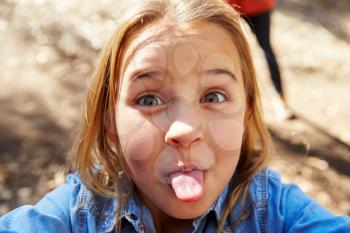 Portrait Of Young Girl Pulling Face For Selfie Photograph