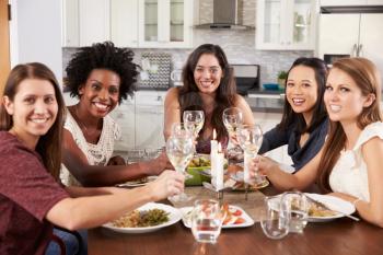 Group Of Female Friends Enjoying Dinner Party At Home