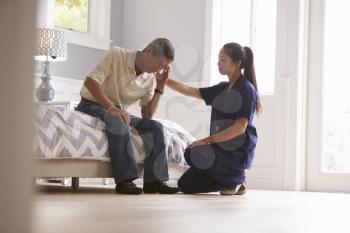 Nurse Making Home Visit To Depressed Senior Man