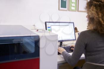 Female Designer Operating CAD System For Laser Cutter