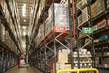Moving stock in a distribution warehouse with an aisle truck