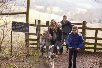 Family with a dog walking in the countryside