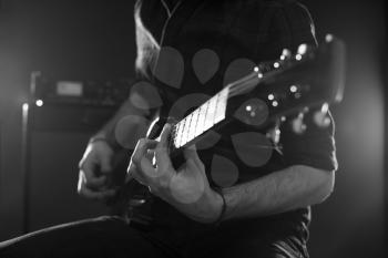 Close Up Of Man Playing Electric Guitar Shot In Monochrome