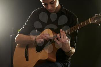 Man Using Tapping Technique On Acoustic Guitar