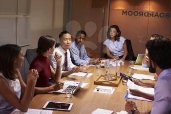Business colleagues in discussion at a meeting in boardroom