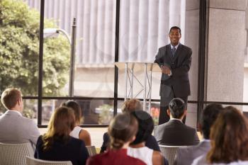 Black businessman presenting seminar smiling to audience