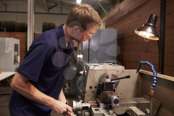 Male Engineer In Factory Using Milling Machine