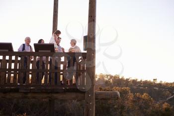 Multi Generation Family Standing On Outdoor Observation Deck