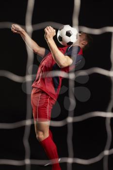 Professional Soccer Player Controlling Ball In Studio