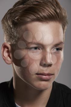 White teenage boy looking away, close up portrait, vertical