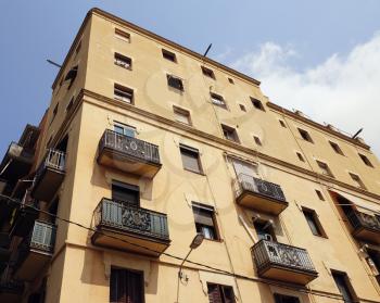 BARCELONA - JULY 29, 2016: Old corner building in Gothic Quarter, low angle view