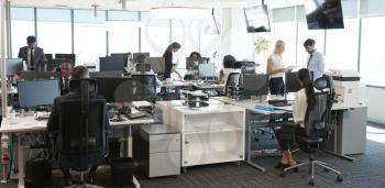 Interior Of Busy Modern Open Plan Office With Staff