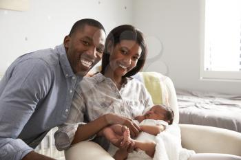 Portrait Of Parents Home from Hospital With Newborn Baby