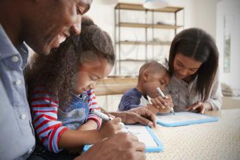 Parents And Children Drawing On Whiteboards At Table