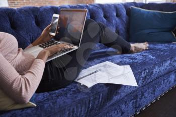 Businesswoman Working On Sofa In Modern Creative Office