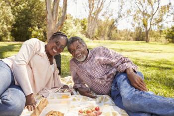 Outdoor Portrait Of Mature Couple Enjoying Picnic In Park