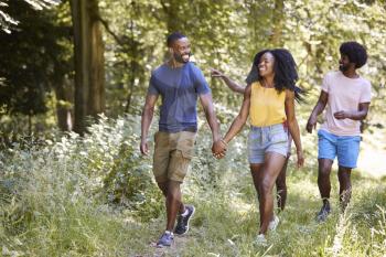 Two black couples walking together in woods