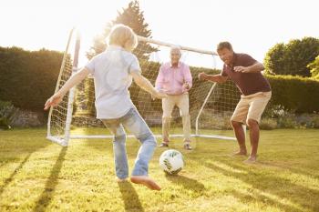 Three male generations of a family playing football