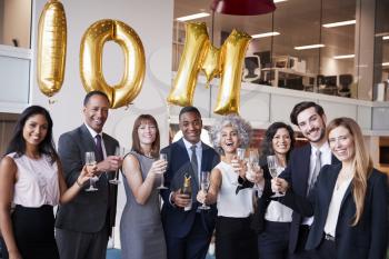 Business people celebrate meeting target in the office