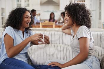 Mother Talking With Teenage Daughter On Sofa