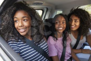 Family With Teenage Children In Car On Road Trip