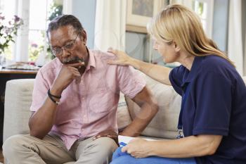 Support Worker Visits Senior Man Suffering With Depression