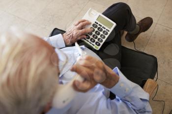 Senior Man At Home Using Telephone With Over Sized Keys