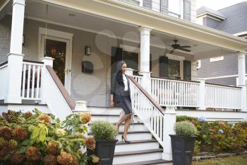 Businesswoman Leaving Suburban House For Commute To Work
