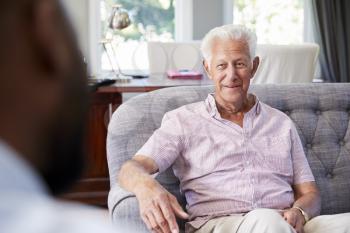 Happy senior man taking financial advice at home