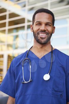 Young black male healthcare worker smiling outside, vertical