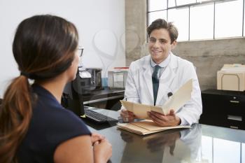 White male doctor in consultation with a female patient