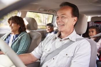 Grandparents with grandchildren in a car on a road trip