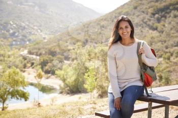 Young mixed race woman taking a break during hike, portrait